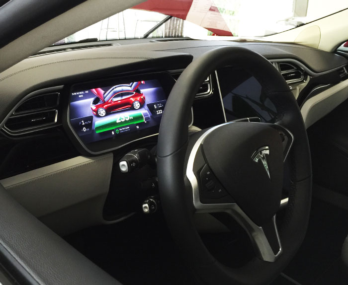 Behind the Tesla wheel.